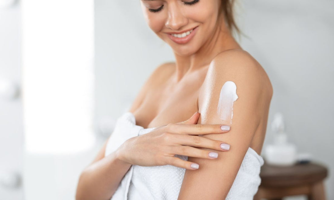women applying dry skin cream on her shoulder 
